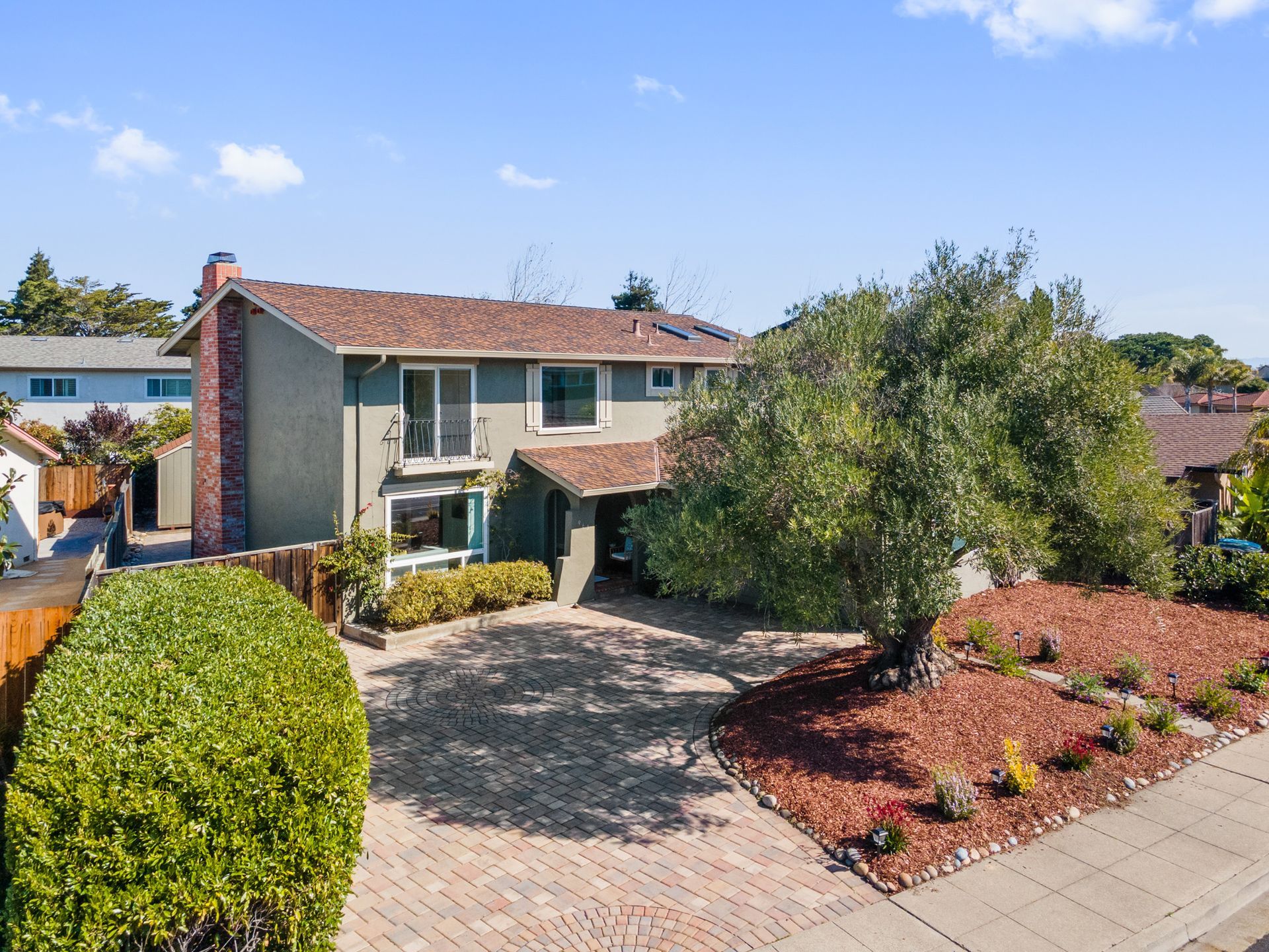 An aerial view of a house with a large driveway