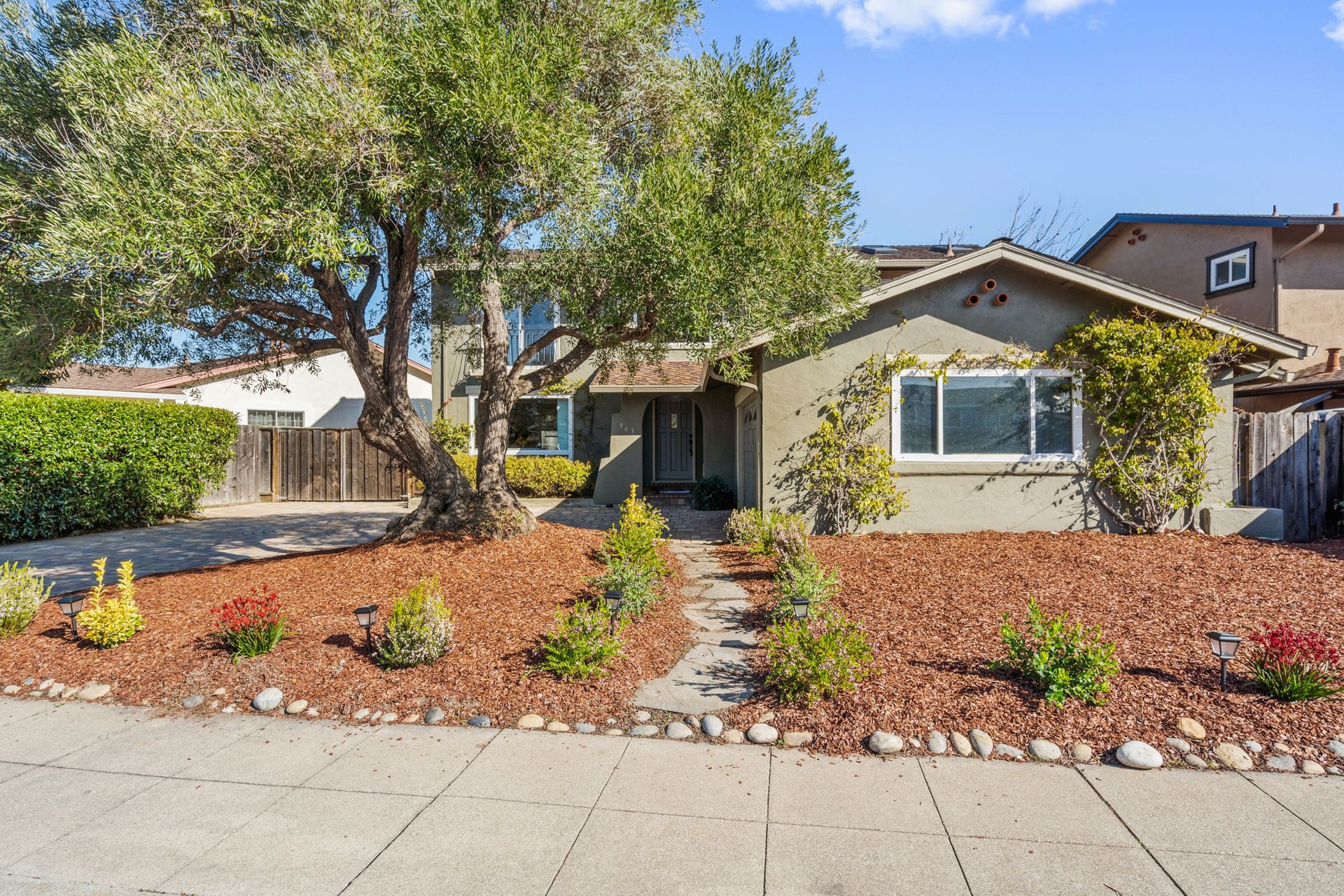 A house with a lot of mulch in front of it