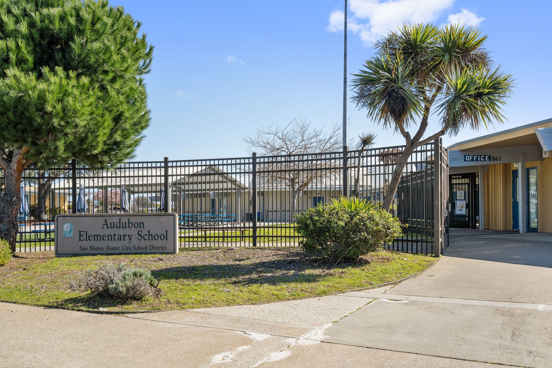 A school with a sign in front of it that says elementary school
