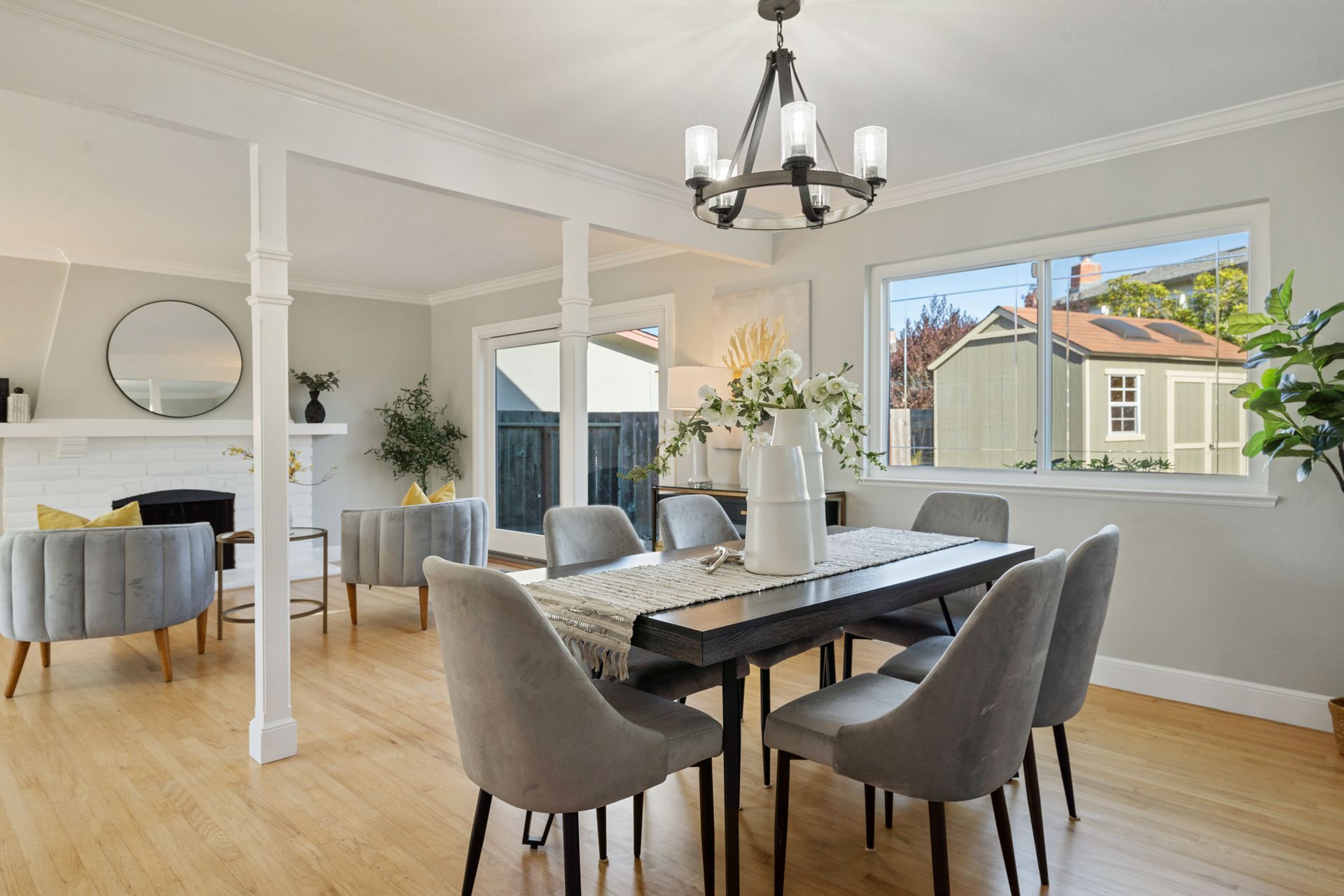 A dining room with a table and chairs and a chandelier.