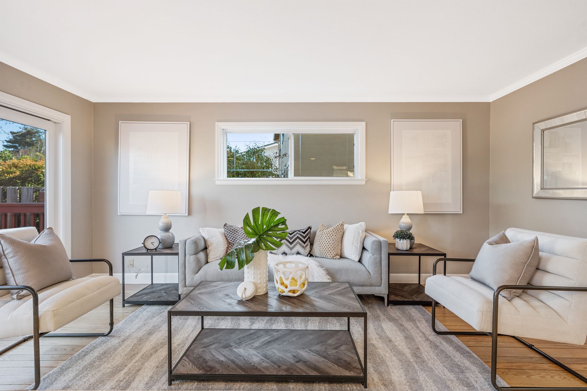 A living room with a couch , chairs , coffee table and sliding glass doors.