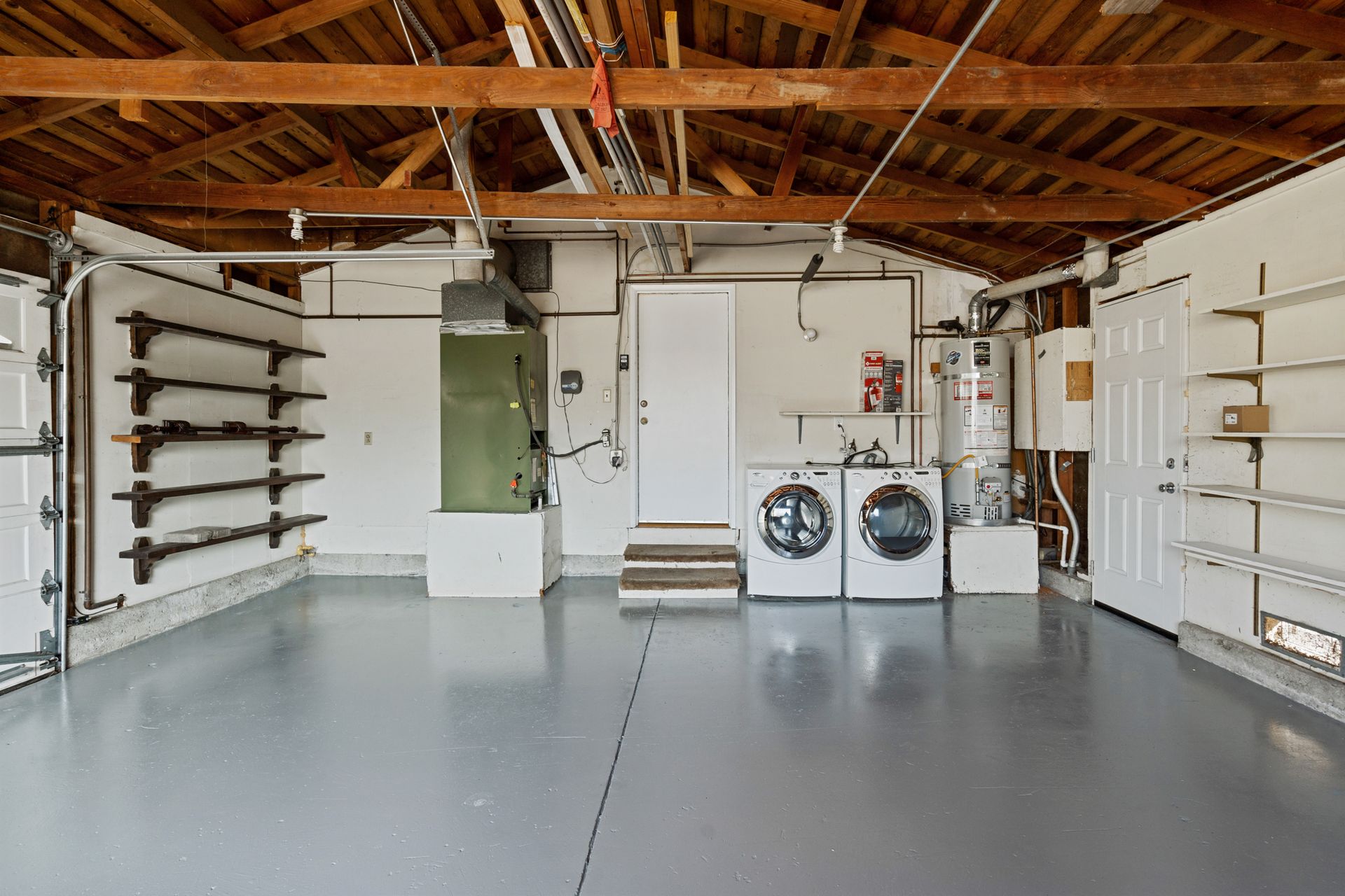 A large empty garage with a washer and dryer.