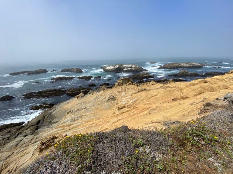 A view of the ocean from a rocky cliff.
