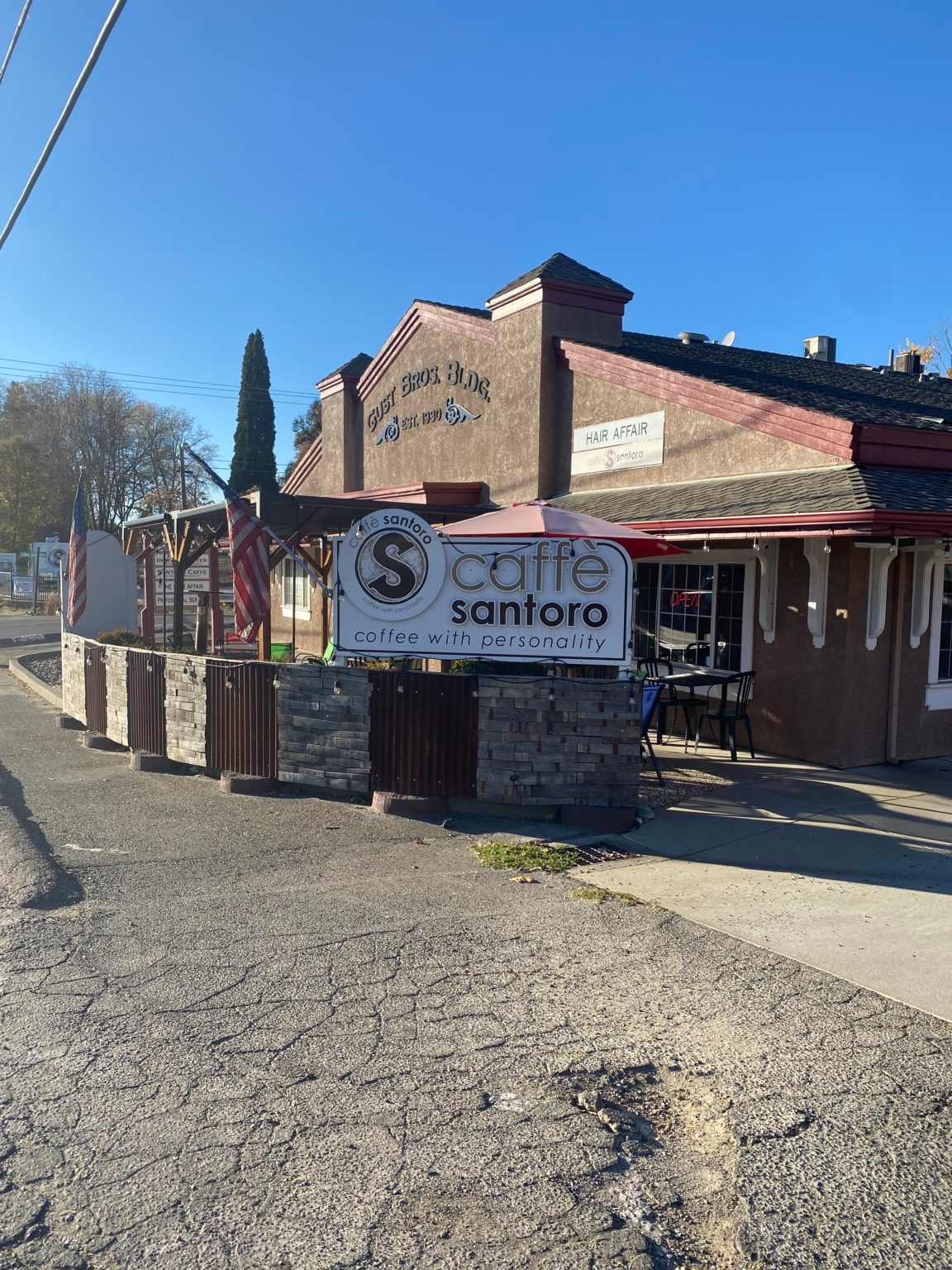 A restaurant with a sign that says ' s cafe santoro ' on it.