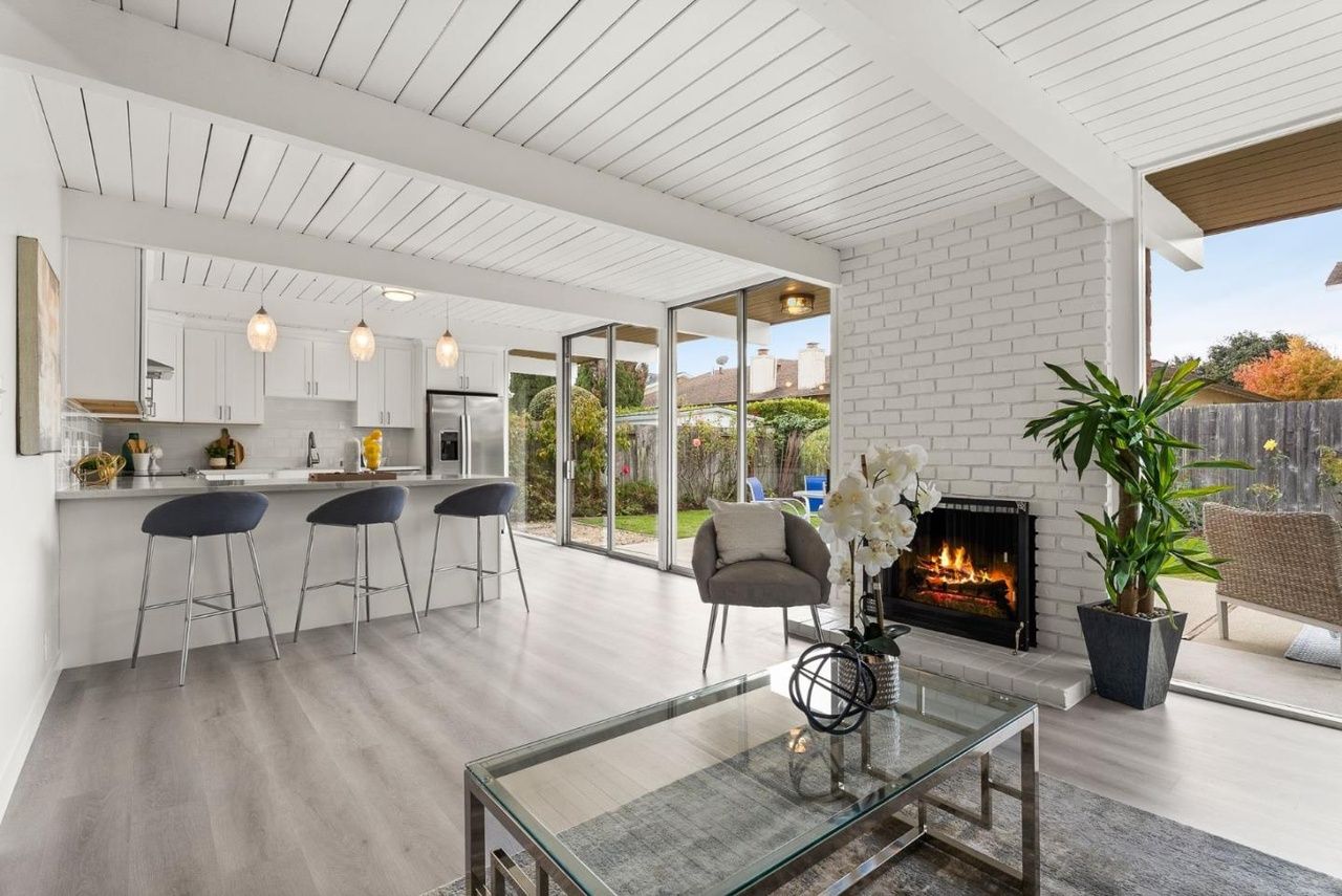 A living room with a couch a table and a fireplace