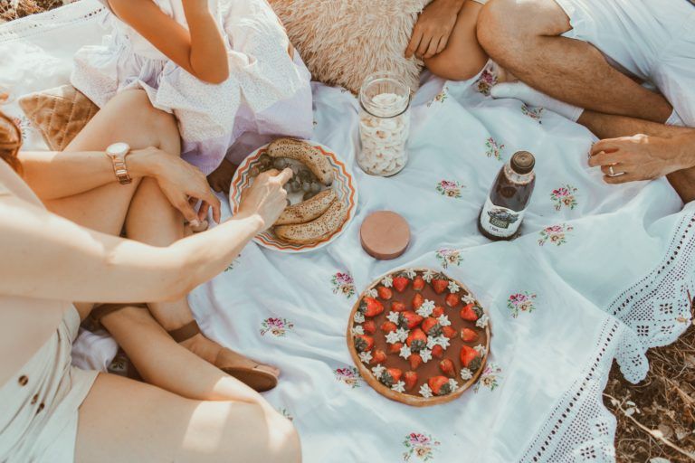 A group of people are having a picnic on the beach.
