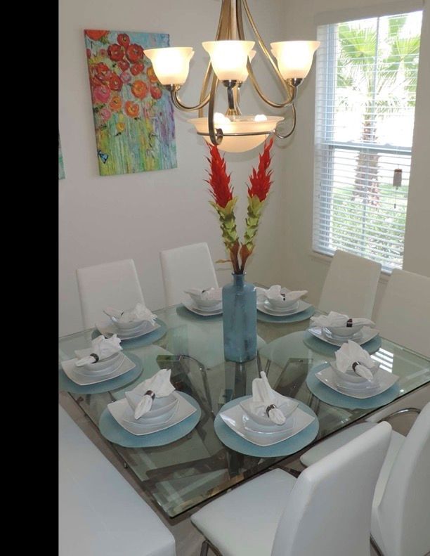 A dining room table with plates and napkins on it