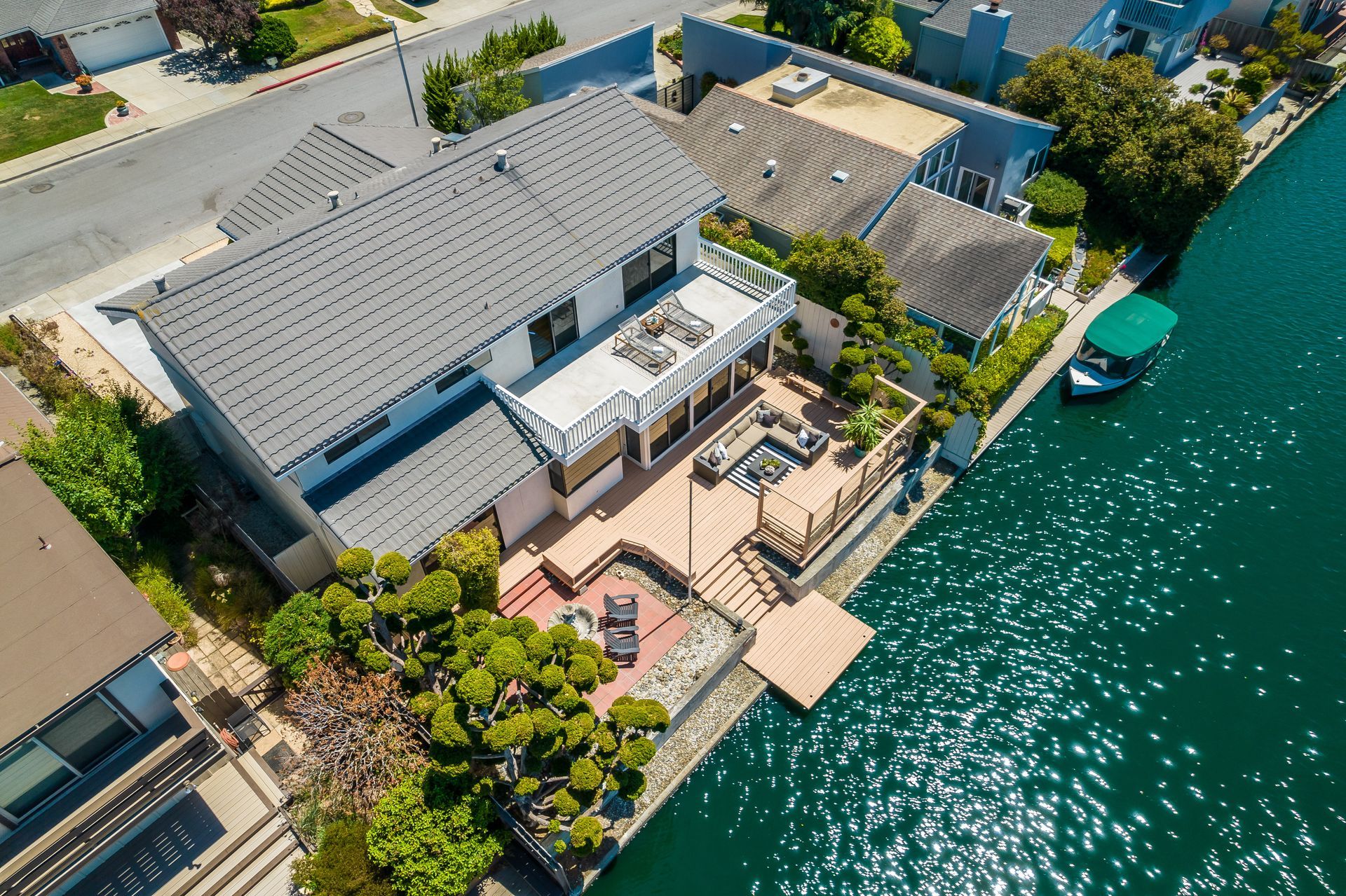 An aerial view of a house next to a body of water.