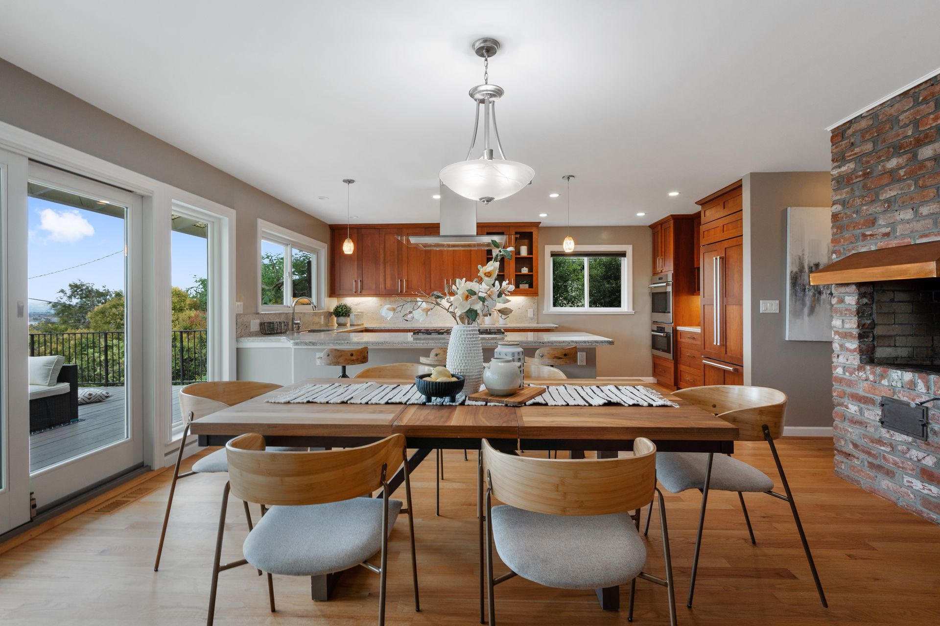 A dining room with a table and chairs and a fireplace.