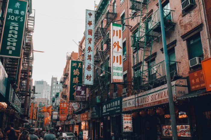 A busy city street with a lot of shops and signs.