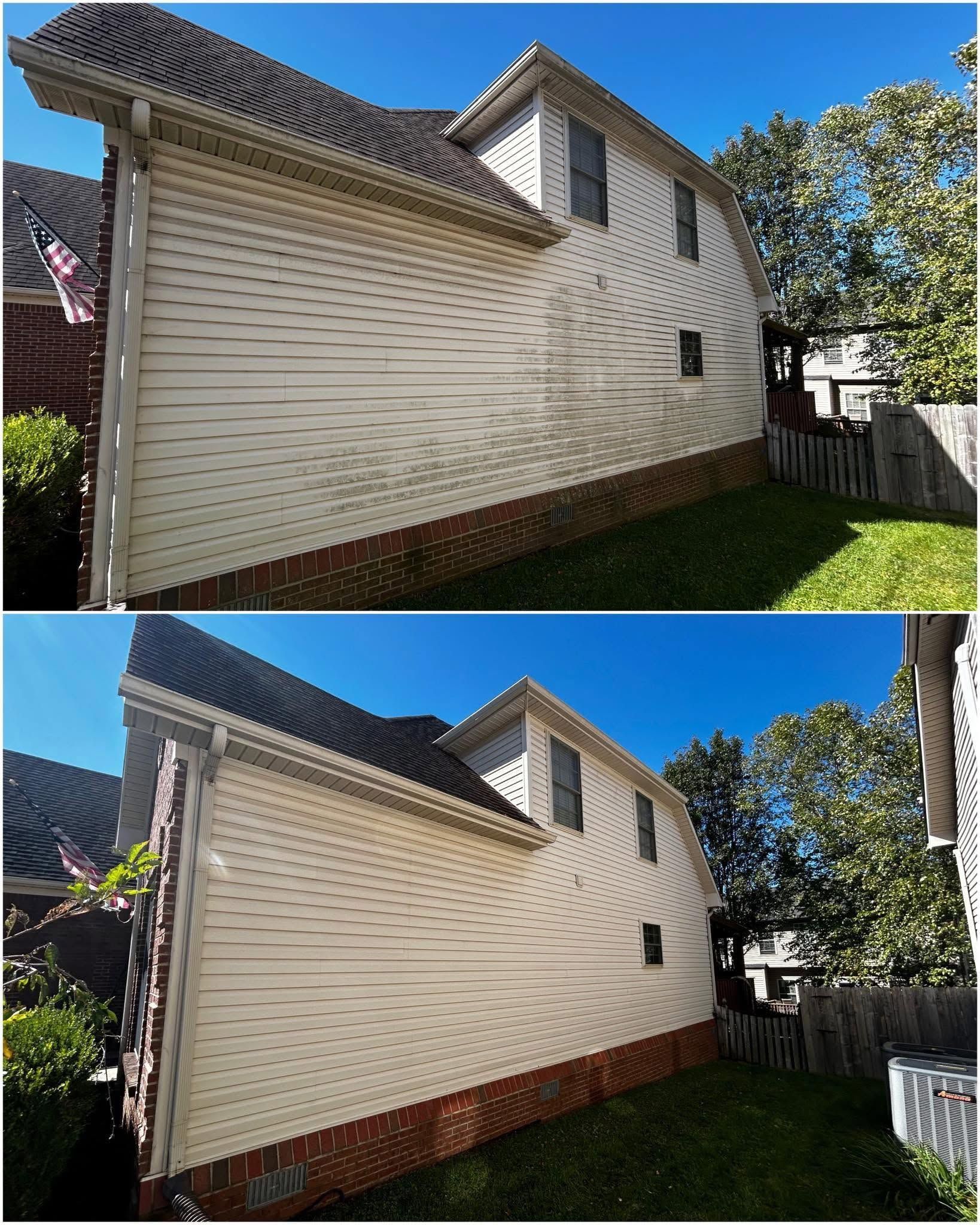 White vinyl house exterior with a tall central chimney, air-conditioning units, and grassy yard under a blue sky