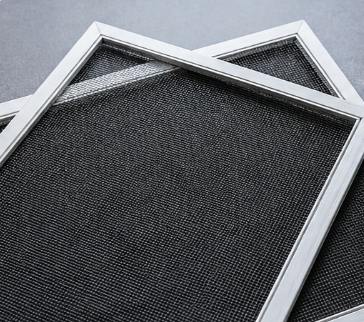 Two overlapping black mesh filters in white frames on a gray background