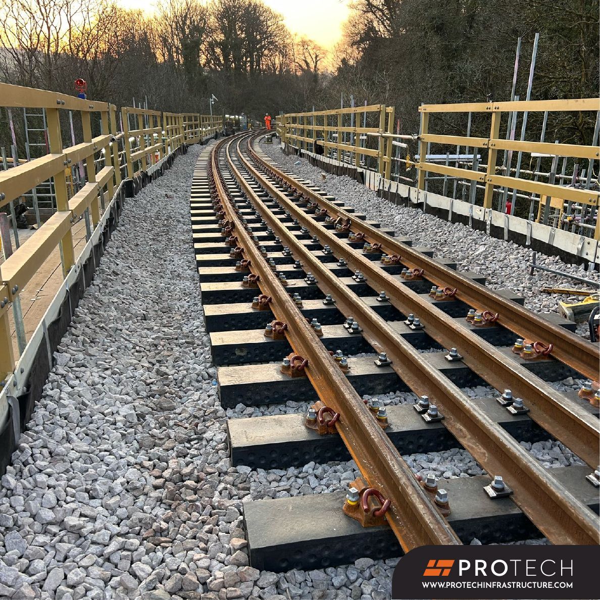 A train track is being built in the woods.