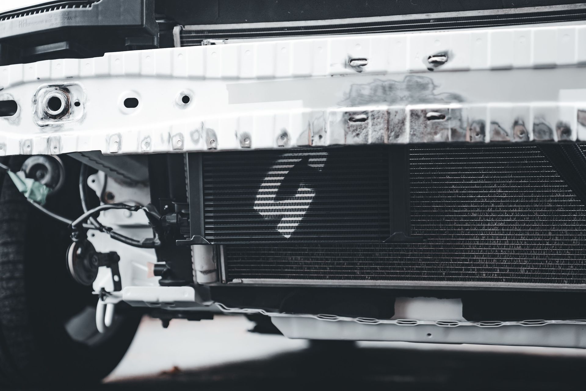 Mechanic pressure-testing a cooling system for coolant leaks