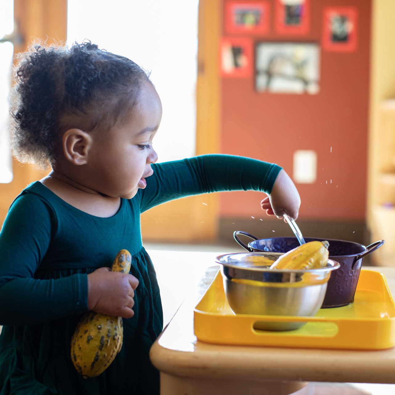 Child working with practical life Montessori materials