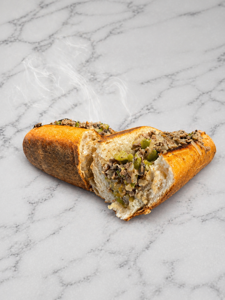 Cut meat sandwich on a marble surface