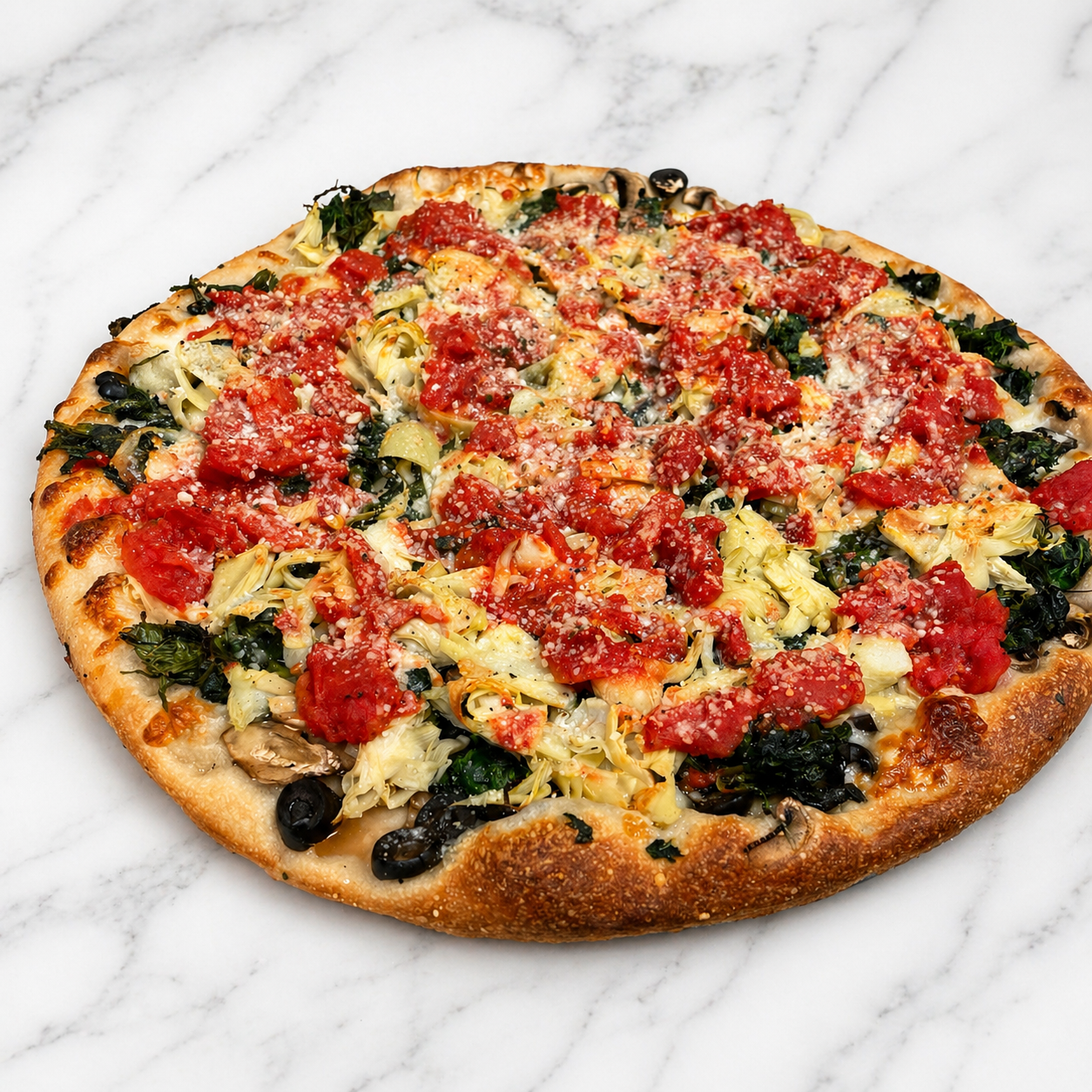 Round pizza topped with red sauce, melted cheese, greens, and golden crust on a white marble surface