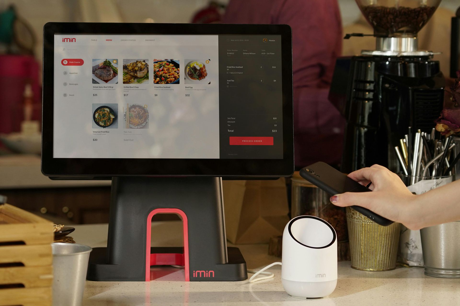 A person is using a smart phone to pay for food at a restaurant.