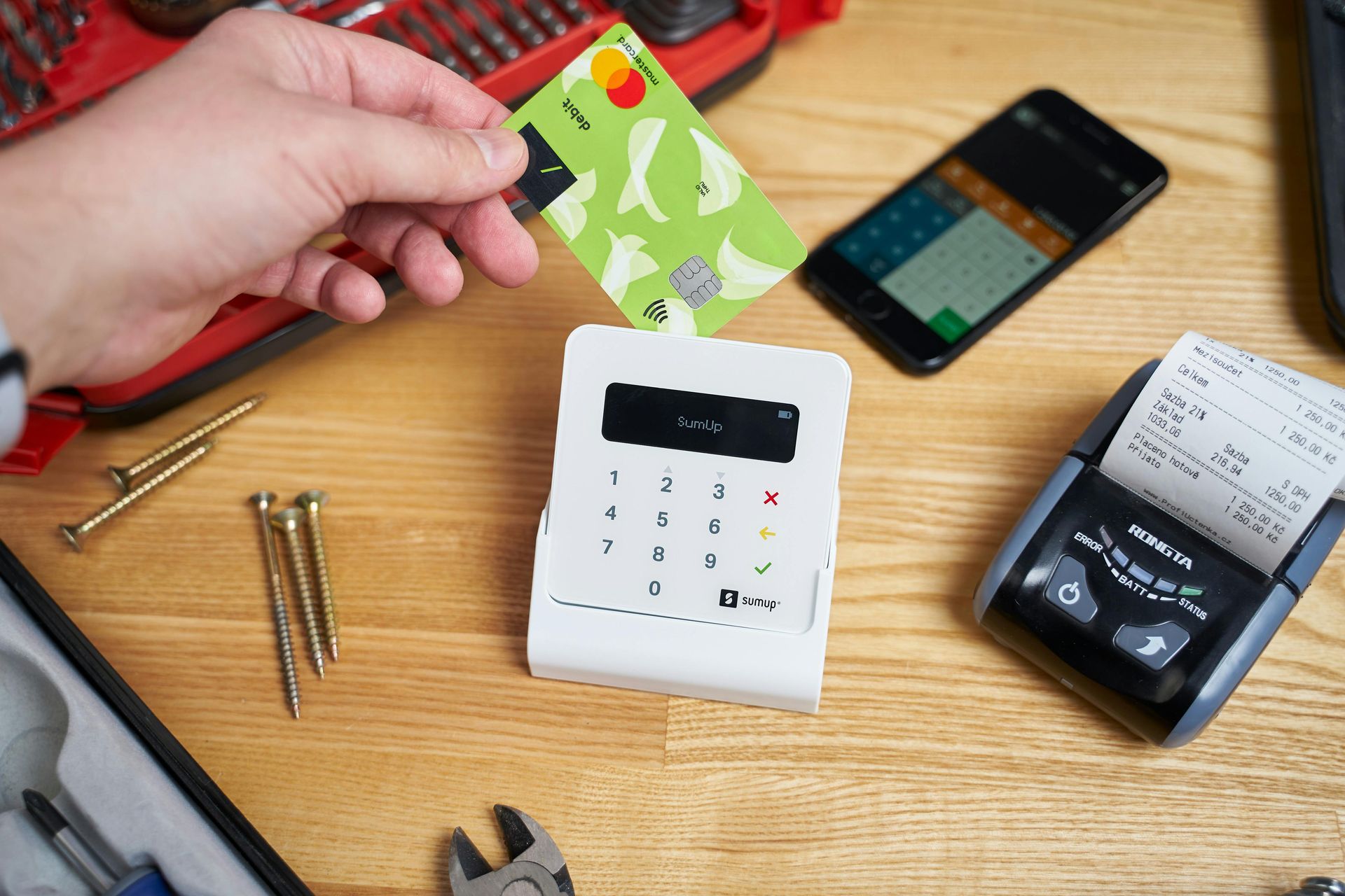 A person is putting a credit card into a machine.