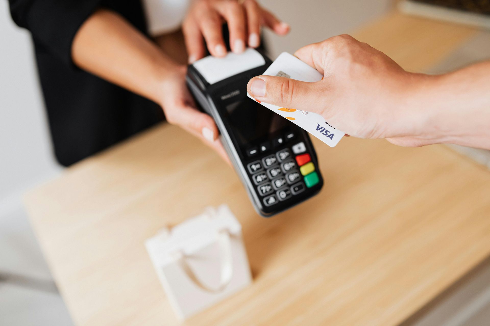 A person is using a credit card to pay for something.