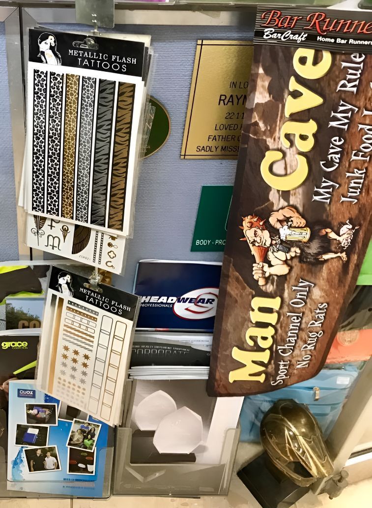 A Man in a Cave Banner is Hanging on a Wall — Central West Trophies & Embroidery In Orange, NSW