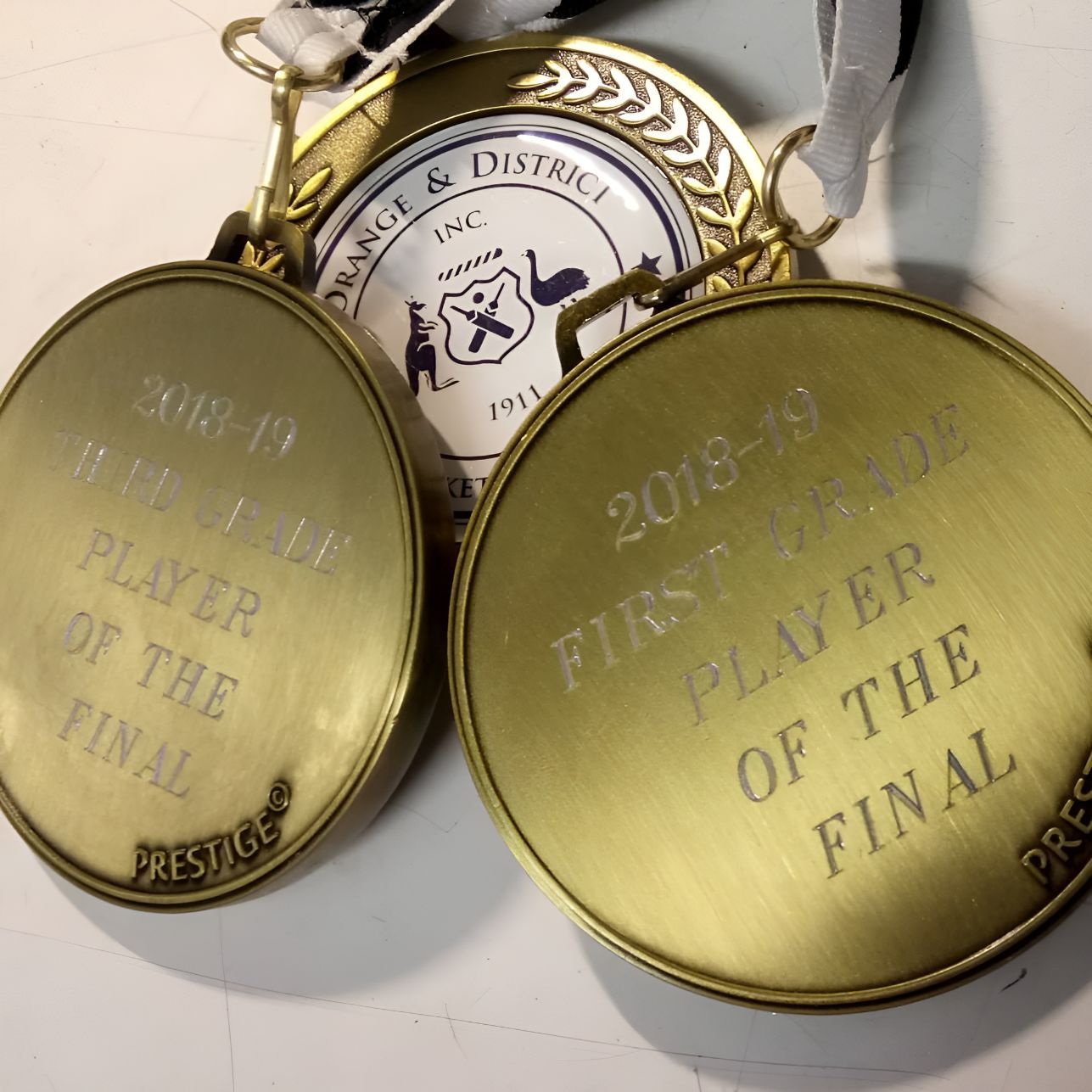 Two Gold Medals That Say First Player of the Final — Central West Trophies & Embroidery In Orange, NSW