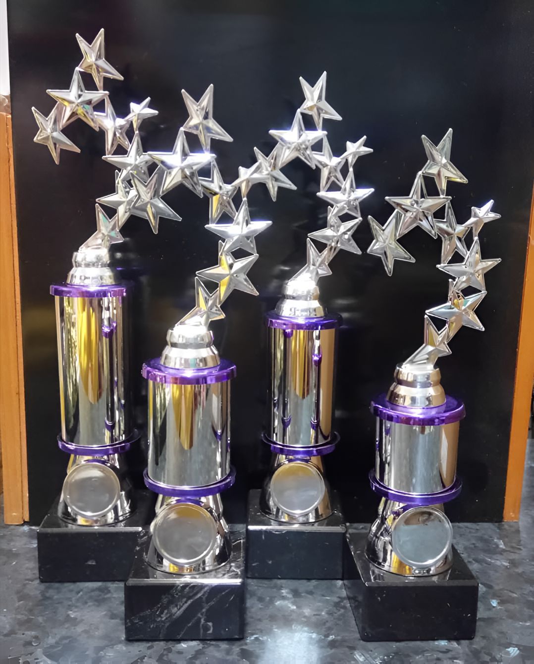 Four Silver Trophies With Purple Trim and Stars on Top — Central West Trophies & Embroidery In Orange, NSW