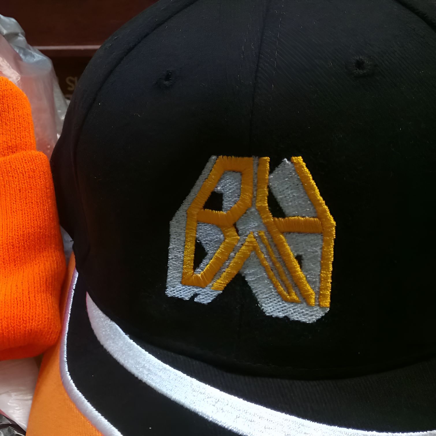 A Black Hat With the Letter N Embroidered on It — Central West Trophies & Embroidery In Orange, NSW