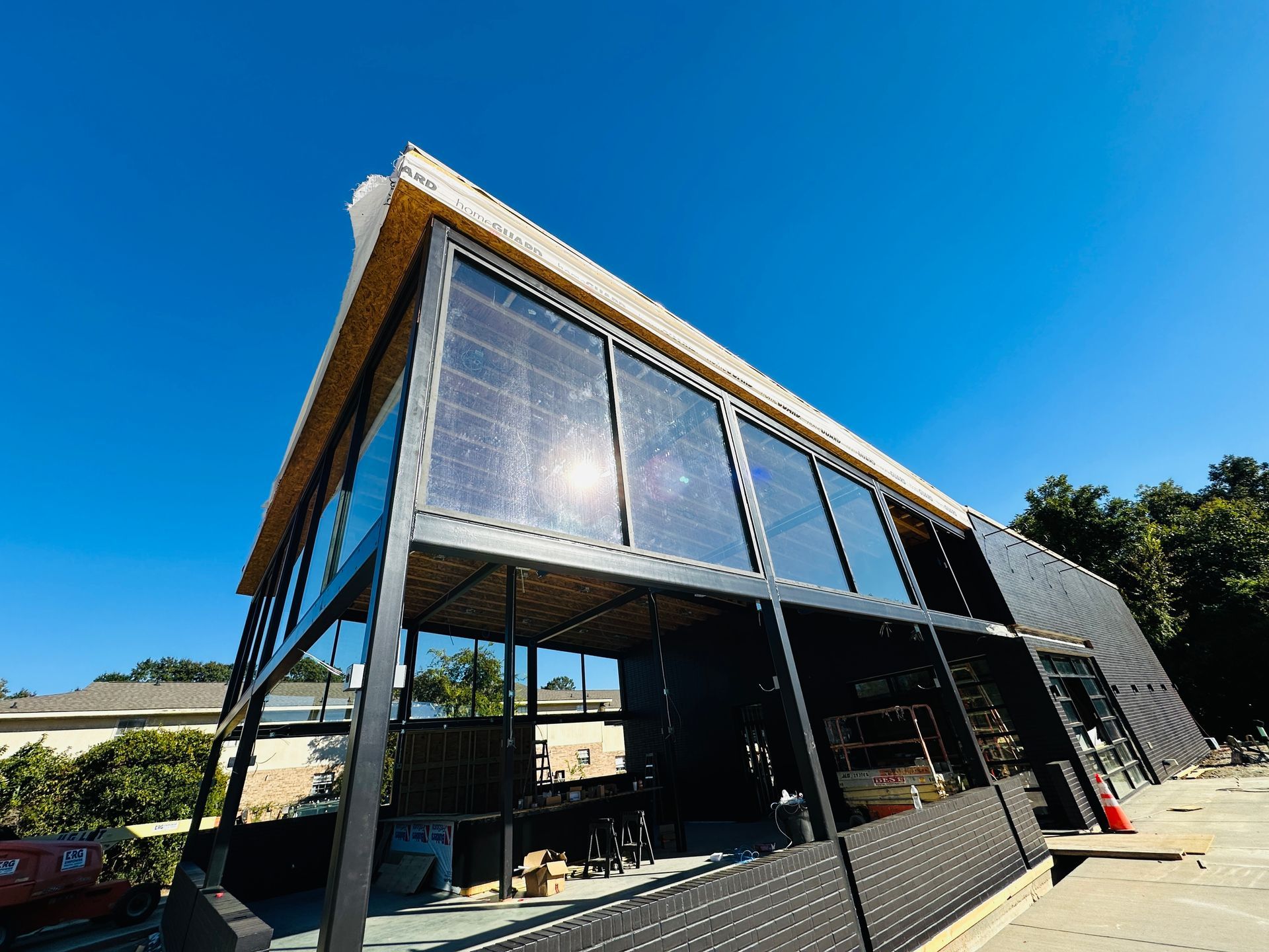 Modern angular building with large glass windows under a clear blue sky