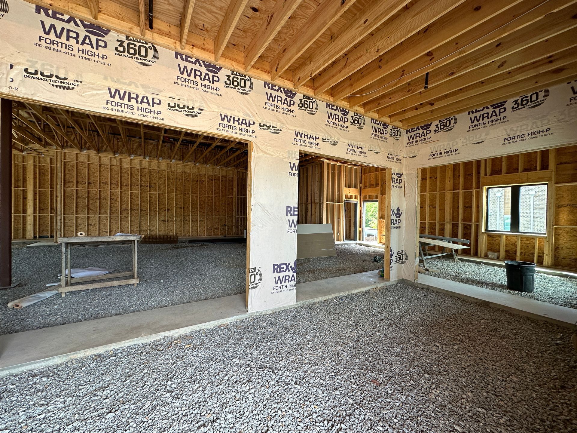A room in a house under construction with a sliding glass door.
