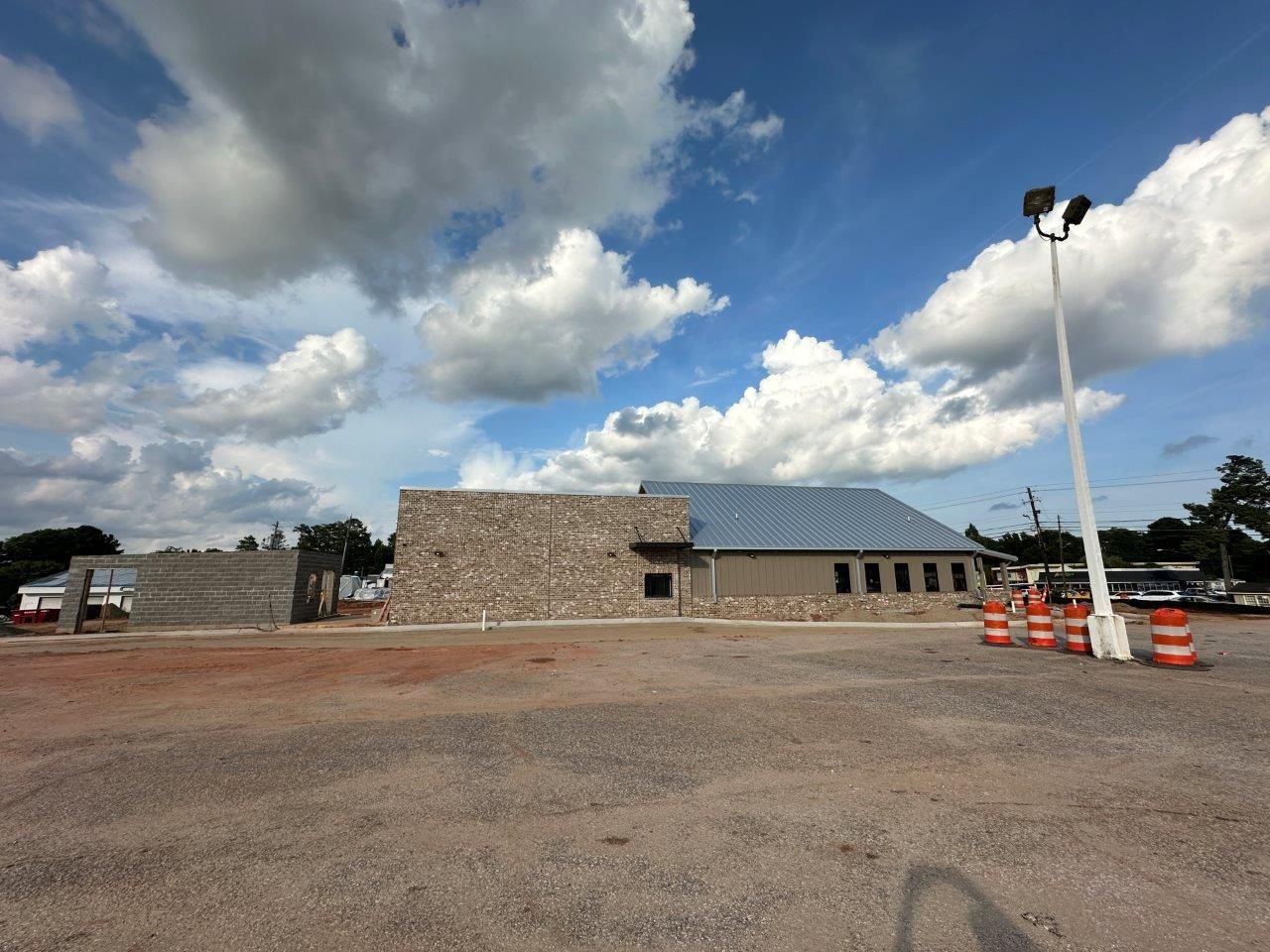An empty parking lot with a building in the background