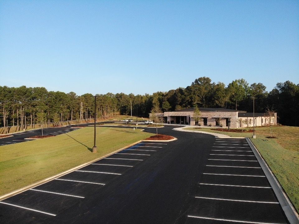 A parking lot with a building in the background