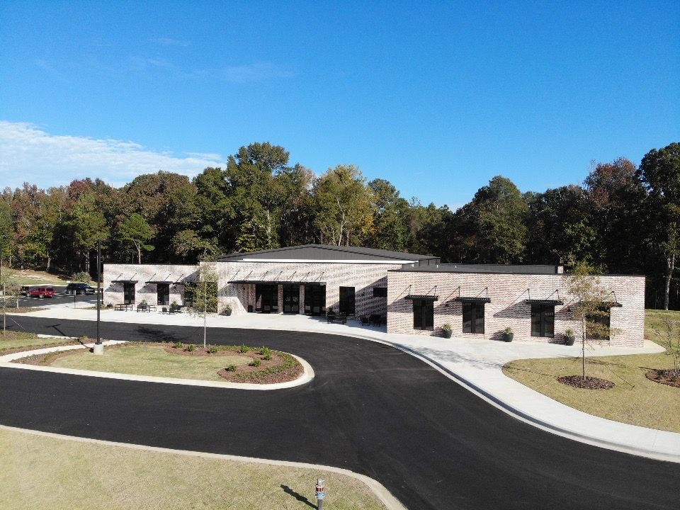 An aerial view of a large brick building with trees in the background.