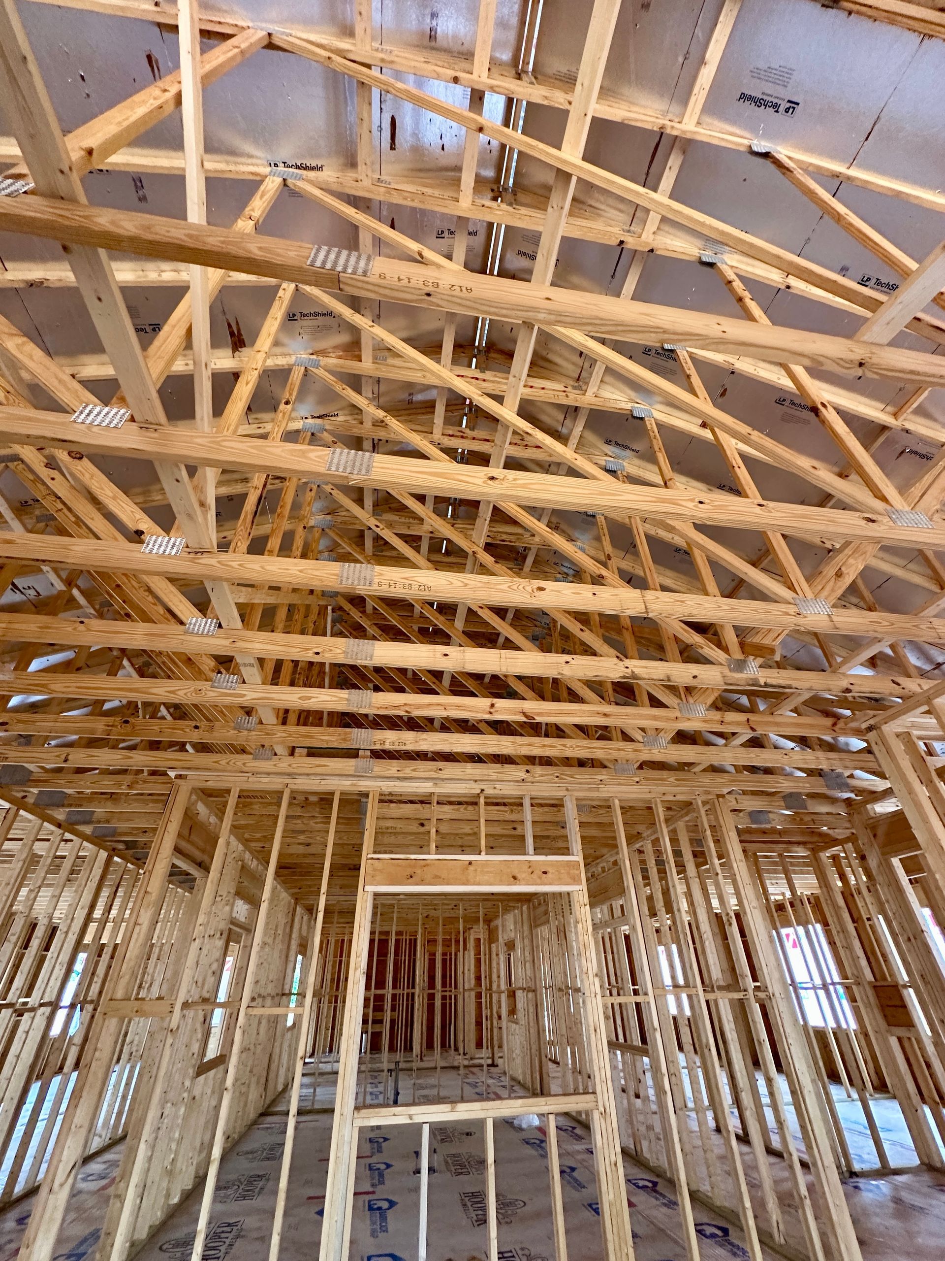 The inside of a building under construction with a lot of wooden beams.