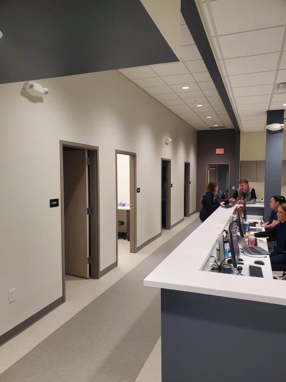 A group of people sitting at a counter in an urgent care building