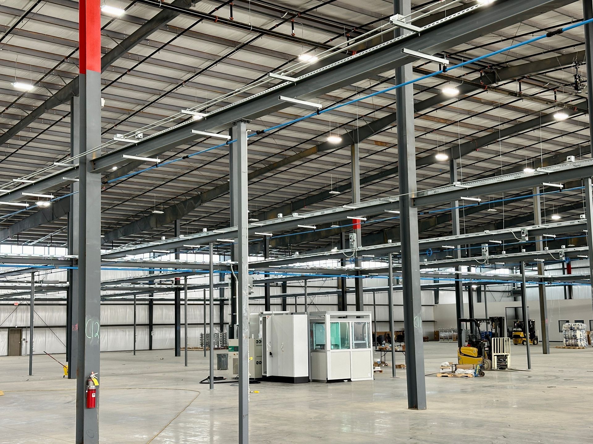 A large warehouse with a lot of machinery in it.