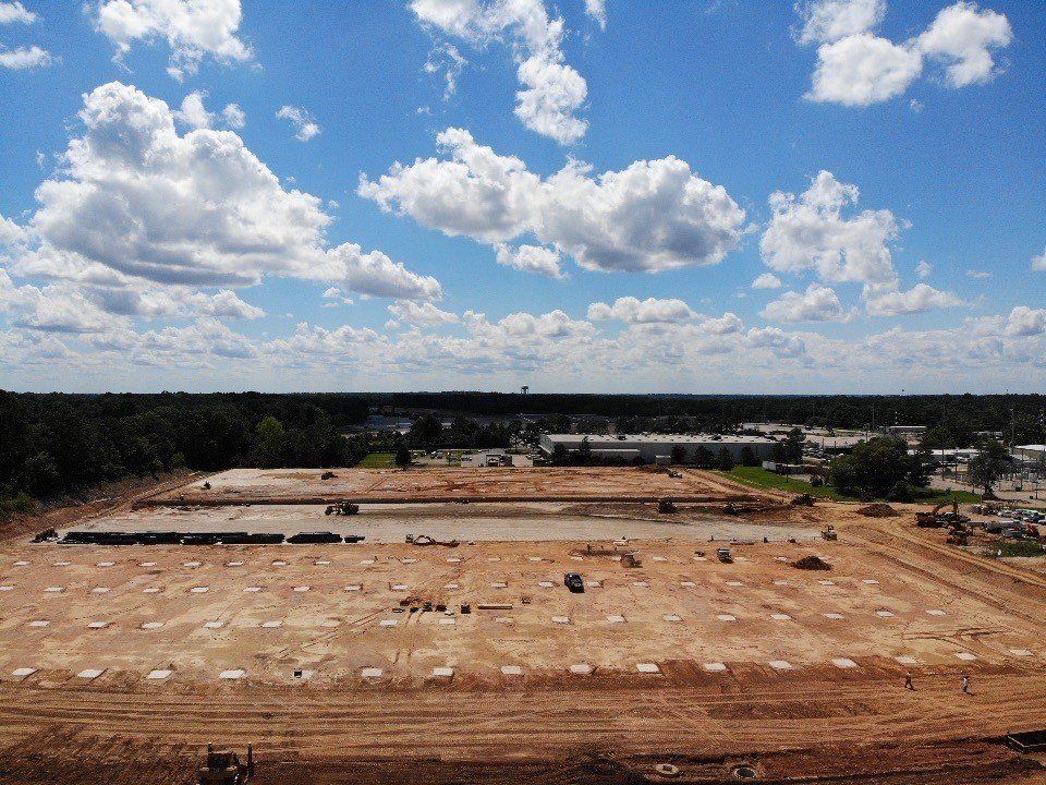 An aerial view of a construction site with clouds in the sky