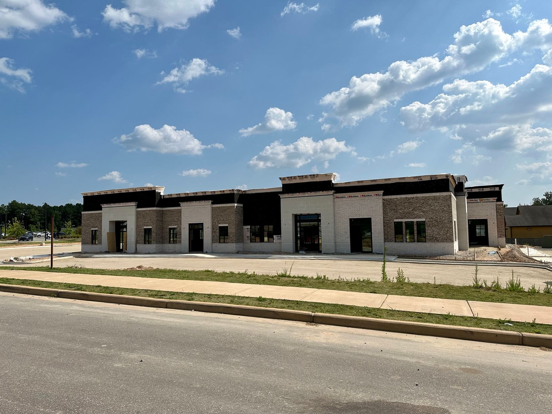A large building is being built on the side of the road.