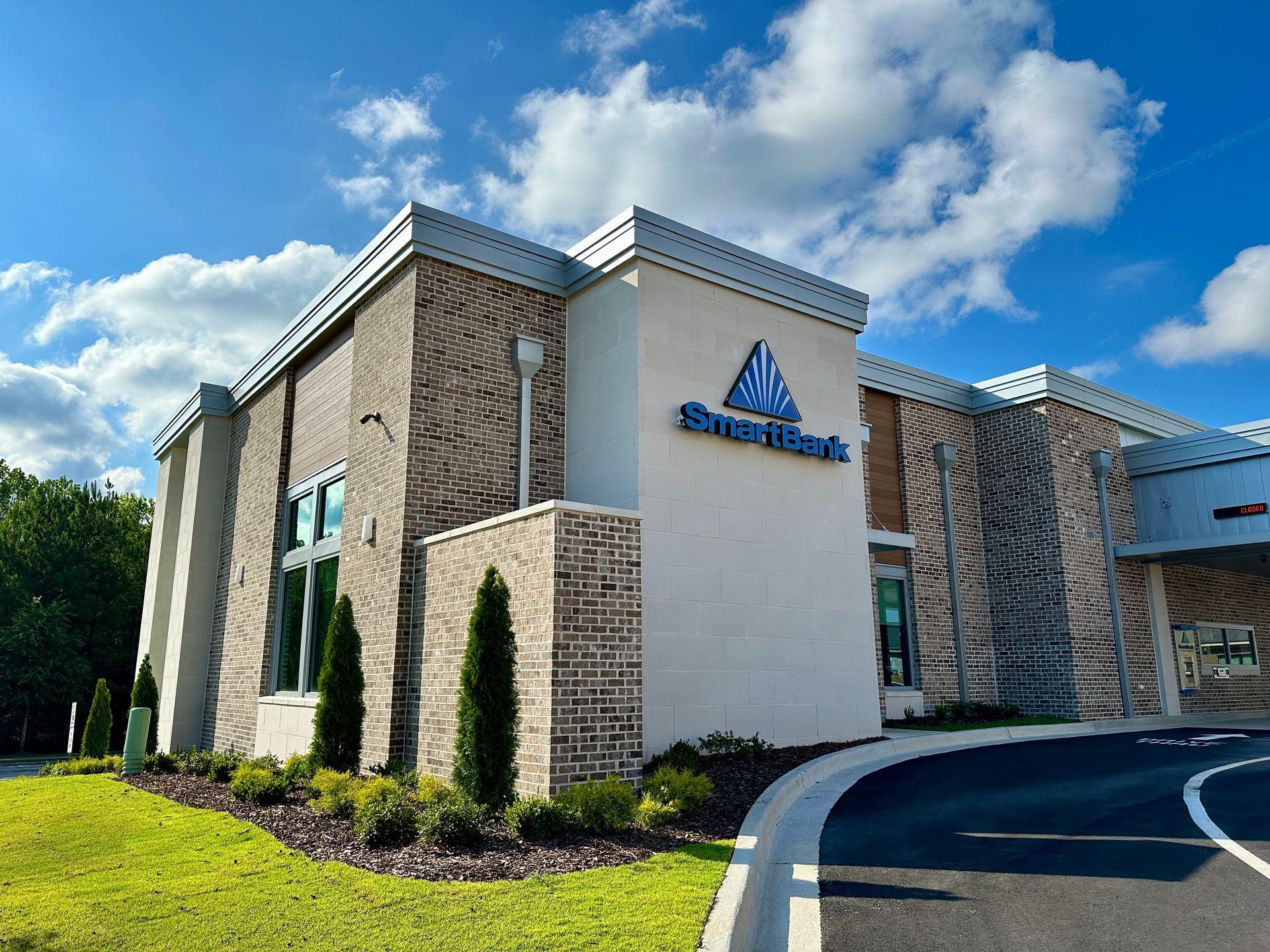 A large white building with a blue sign on the side of it.