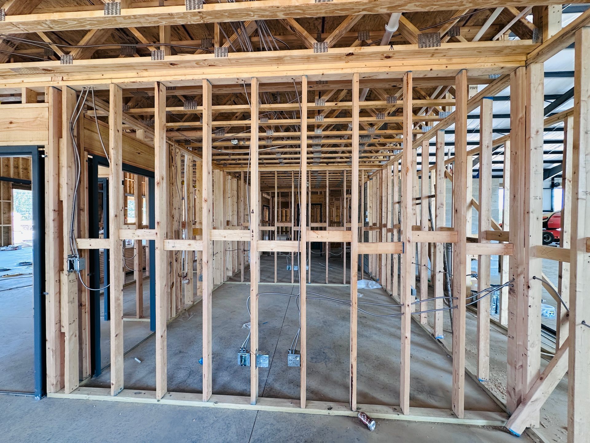 Interior of a house under construction with exposed wooden framing and unfinished walls