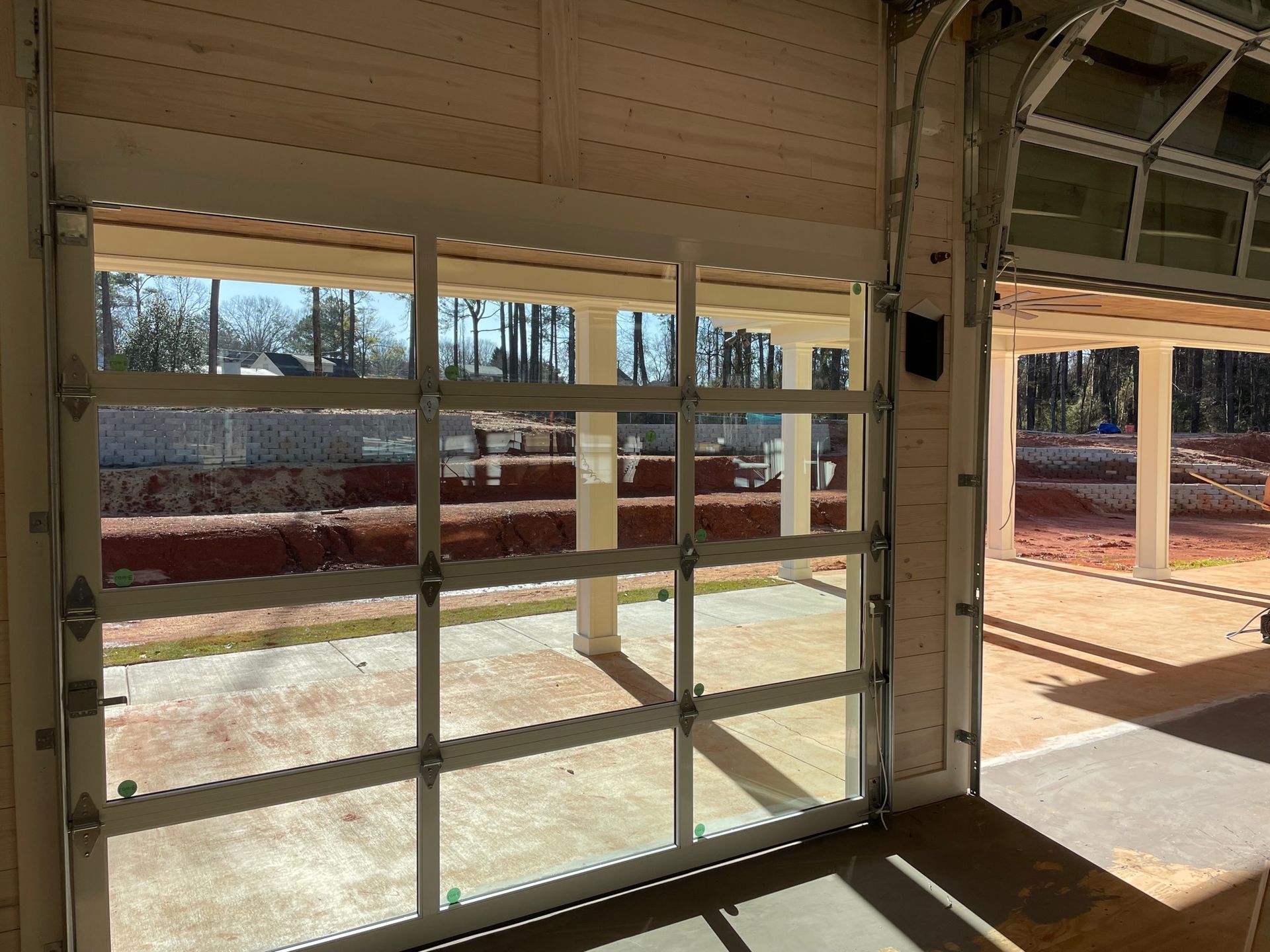 A garage door with a lot of windows and a view of the outside.