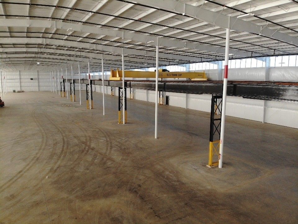 A large empty warehouse with a lot of shelves