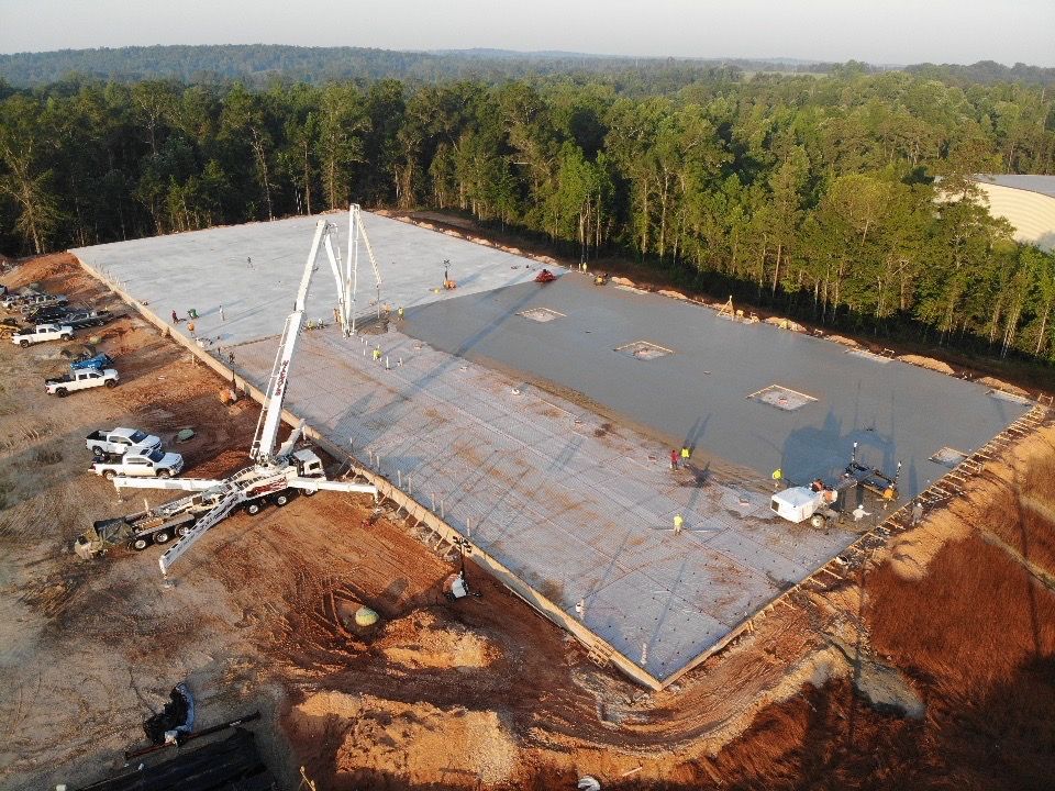 An aerial view of a large construction site with a concrete pump.