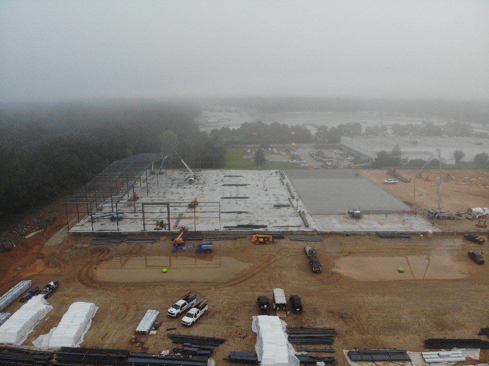 An aerial view of a construction site on a foggy day.