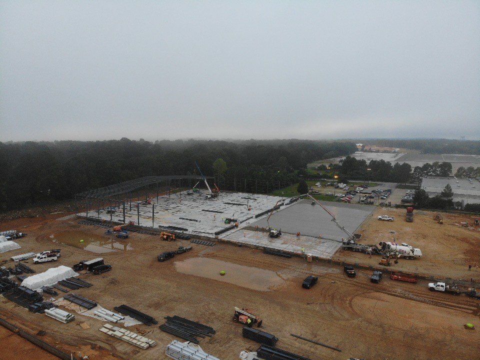 An aerial view of a construction site on a cloudy day.
