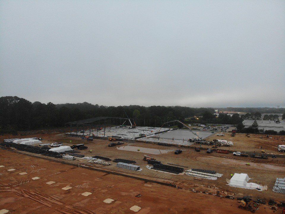 An aerial view of a construction site on a cloudy day.