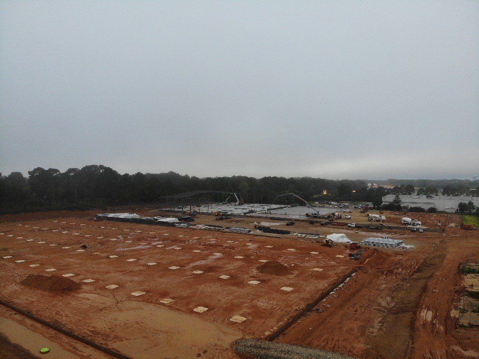 An aerial view of a construction site on a cloudy day.