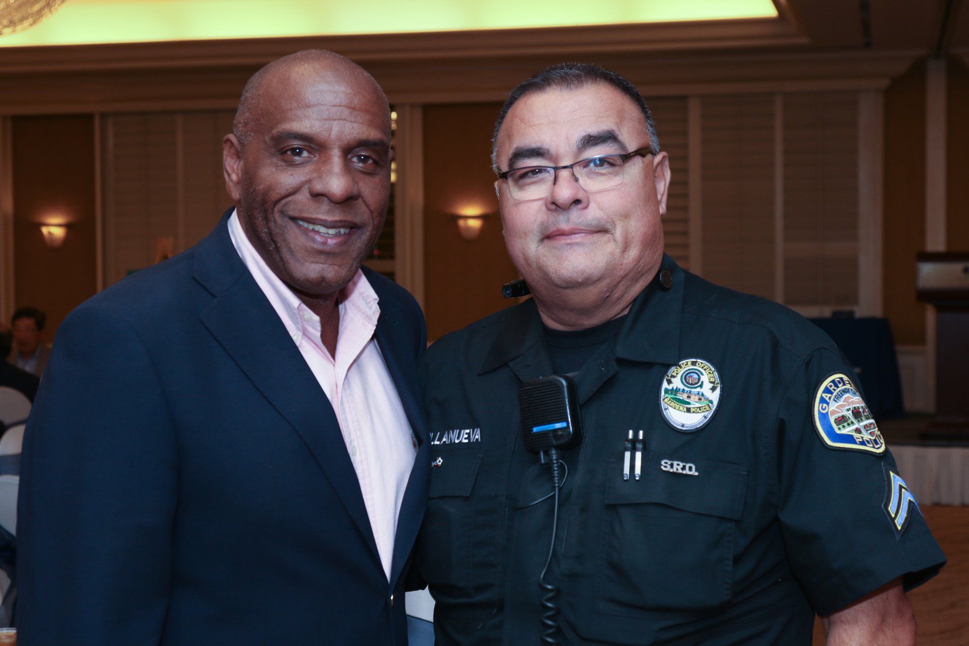 Two men in police uniforms are posing for a picture.
