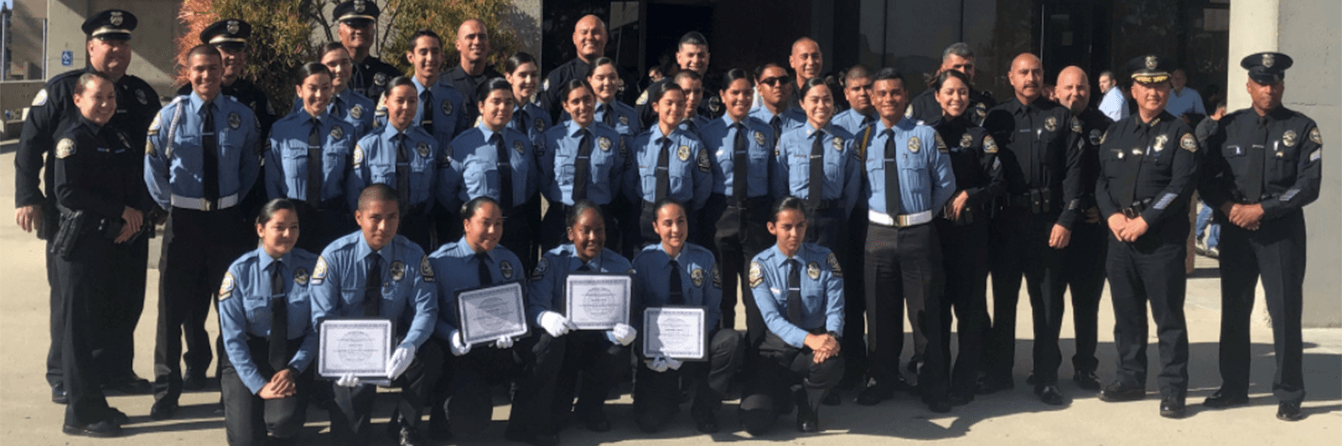 A large group of police officers are posing for a picture.