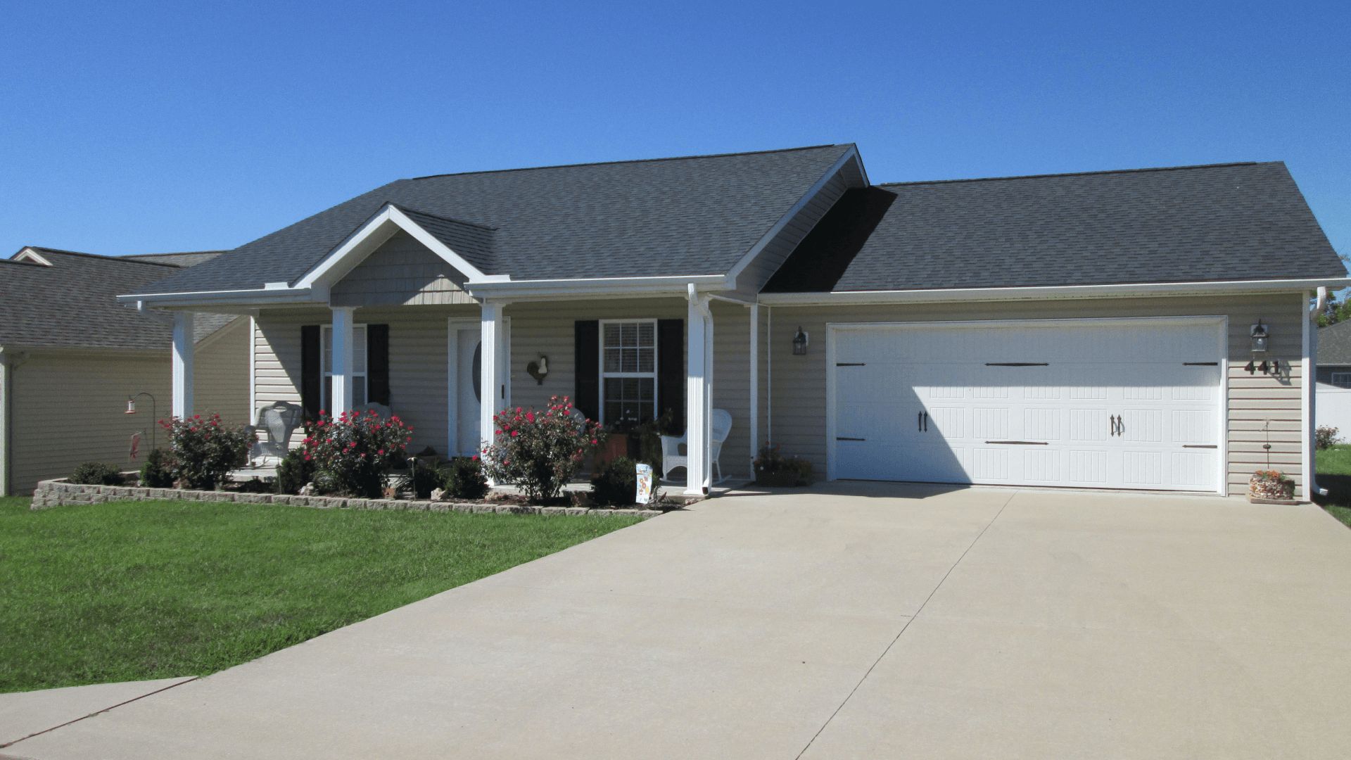 Single-story suburban house with a two-car garage and a concrete driveway
